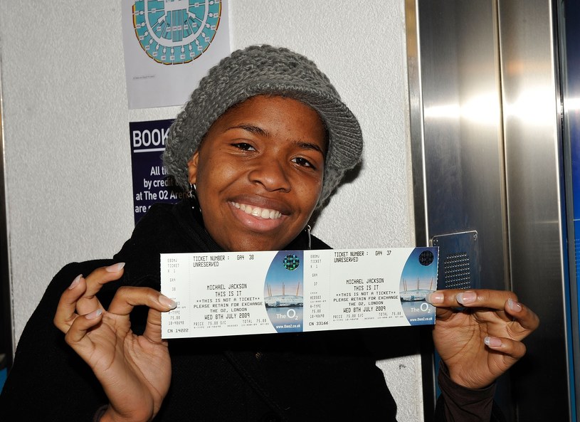 Happy fan with a ticket to a Michael Jackson concert /Simon James/WireImage /Getty Images